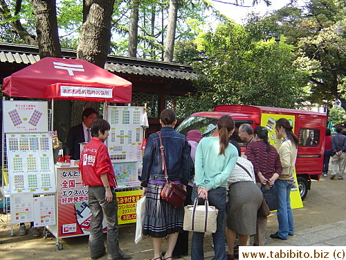 Hardworking postal staff set up a stand to sell sheets of stamps inside Nezujinja on Sunday