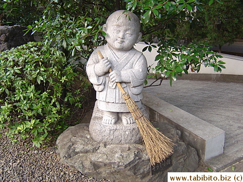 Monks in temples do sweep a lot, even the statue reflects that