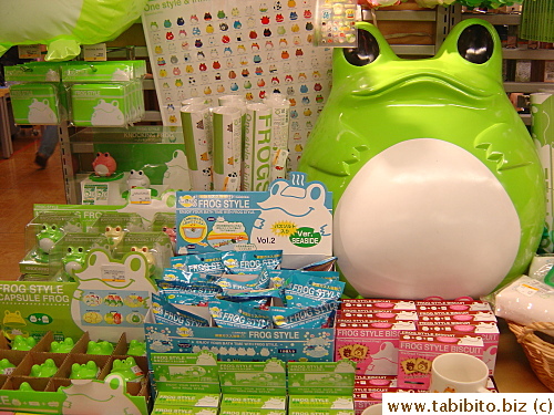 A table full of frog style toys, stationery, accessory and food