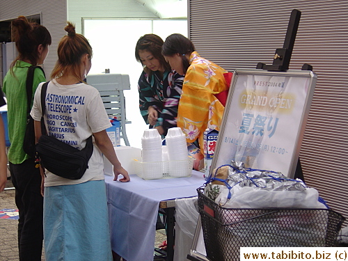 Women dressed in yukata sell shaved ice with syrup on the street, a very popular treat (the ice, not the women) in summer here