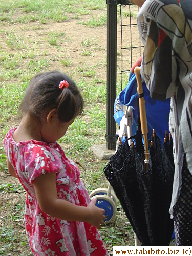 This little girl caught two dragonflies. After she showed them to her granny, the woman told her to release them.  One flew away and the other landed on her dress for a brief moment