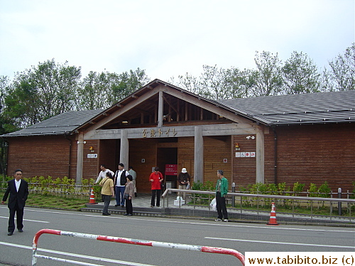 A public restroom made of logs