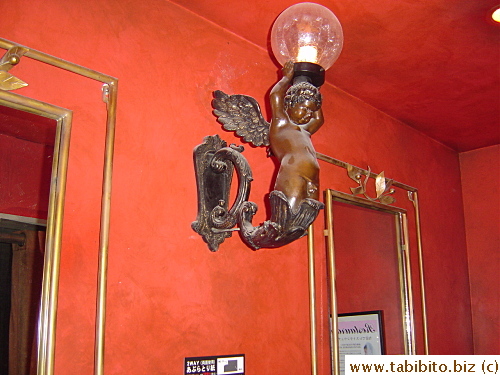 Naked cherubs adorn the walls in ladies restroom