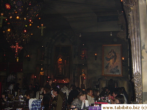 One wall of the restaurant decorated like the catholic church