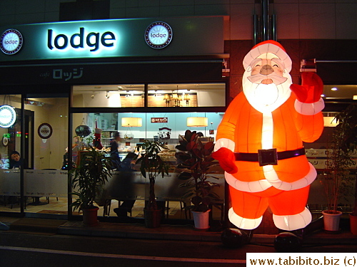 A giant happy Santa welcomes diners