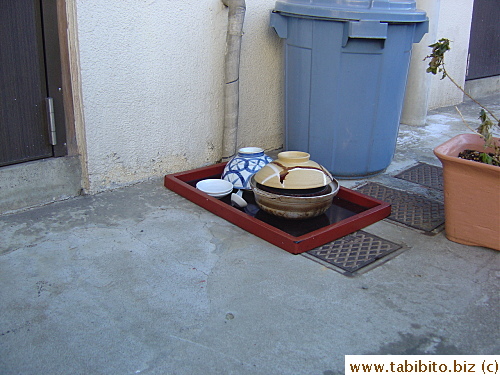 Used dishes from delivered food left outside this apartment waiting to be picked up