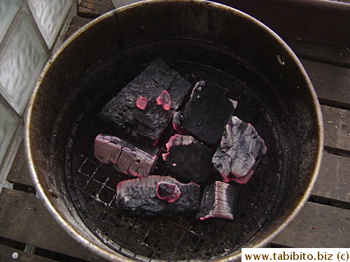 When the charcoal is ready, I transfer it to the grill