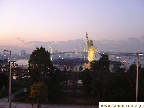 Rainbow Bridge and Statue of Liberty at night