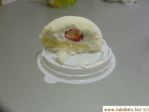 There is a layer of sponge cake, whipped cream and a whole strawberry underneath the shell