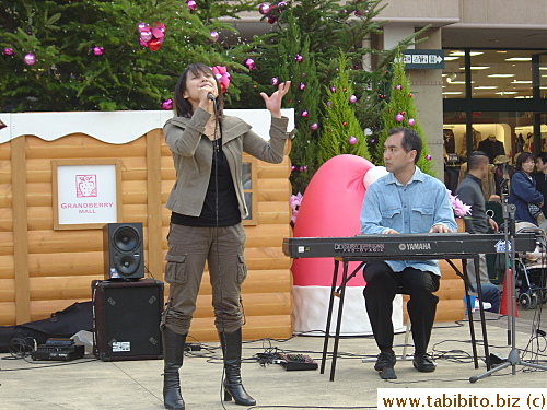 A vivacious singer performs for shoppers