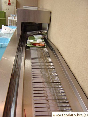 Diners put their trays of dirty dishes on the conveyor belt which transports them to the washing area in the kitchen