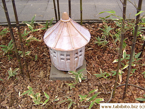 A stone lantern amidst bamboo plants