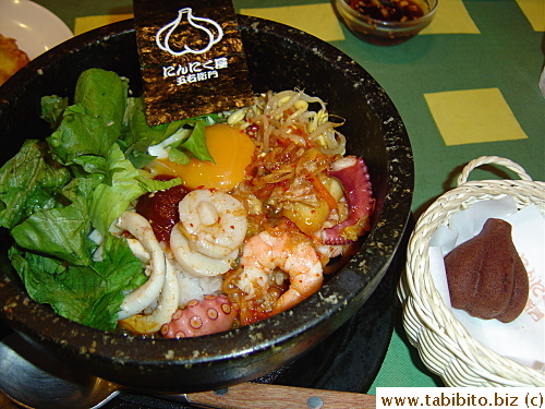 My seafood rice in a stone bowl (Bibinpa).  The bowl wasn't heated probably, thus the crispy crust on the bottom was nowhere to be seen, and the rice wasn't sizzling when it arrived.  Taste was OK though.  The garlic-shape chocolate cake was the dessert part in KL's set, he didn't like the texture of it