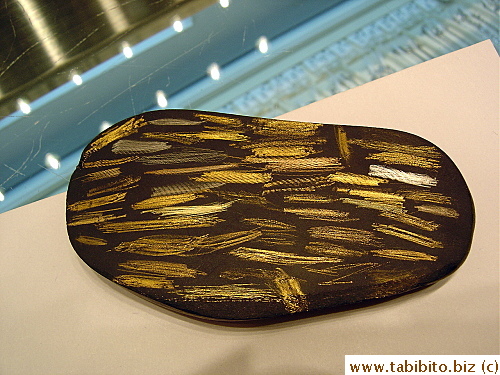 Gold jewelry's authenticity is revealed instantly by scrubbing on this Gold Tester Stone as shown by the staff at Chow