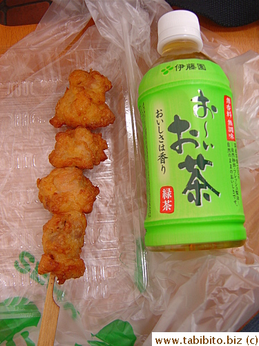 A stick of Karaage (fried chicken) and green tea