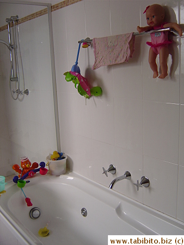 There's a creepy doll above the kids' bath tub 