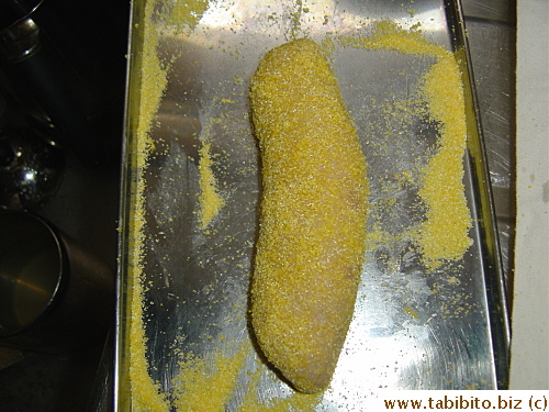 the roll is spritzed with water and rolled in cornmeal