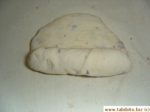 After 10 min, the dough is flattened and rolled up