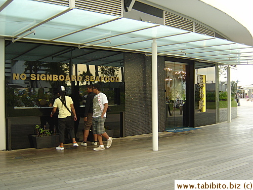 People checking out the fish tanks of the restaurant