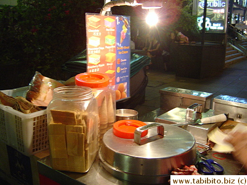 Icecream vendors are popular at night with made-to-order icecream sandwich (using wafers or bread)