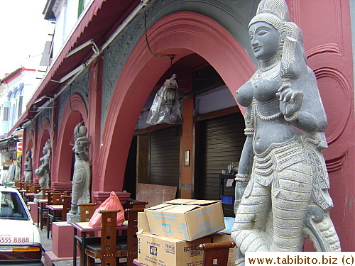 Statues bordering a restaurant