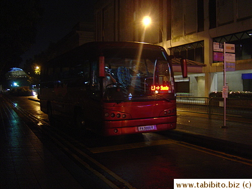 The stop is on the street next to the station