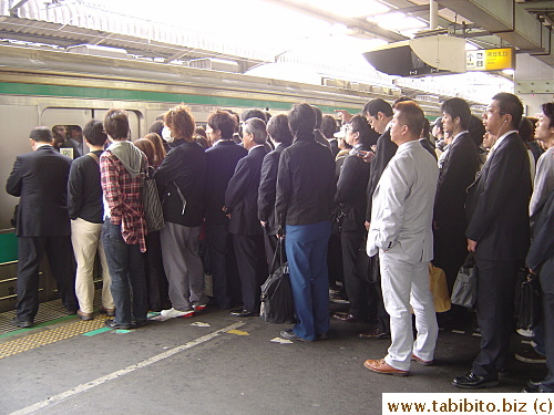 At a connecting station, tons of passengers wait for the train going into town.  At the final station where we got off, it's so packed that for a brief moment, we were stuck on the platform unable to move.  People filled up all the space including the stairs