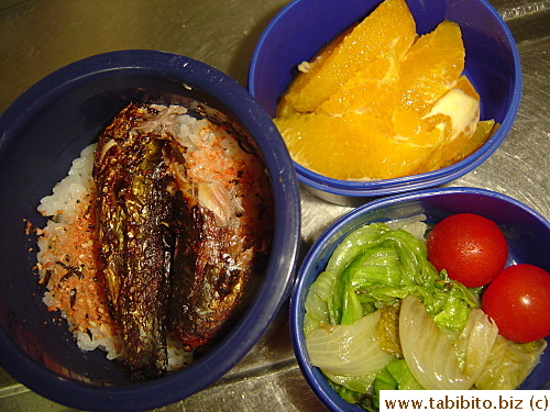 Grilled stuffed sardine and Furikake over rice, sauteed lettuce, cherry tomatoes, orange