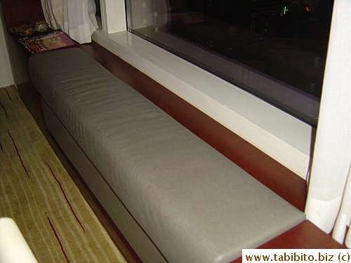 Cushioned bench style seat by the window
