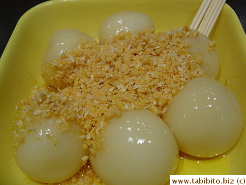 Plain chewy rice balls served with crushed roasted peanut, sugar and coconut