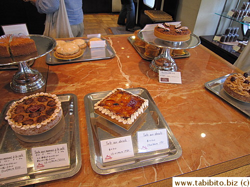 Pies on the table between the counter and the tables