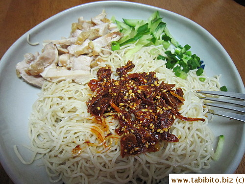 Over chilled noodles and steamed chicken