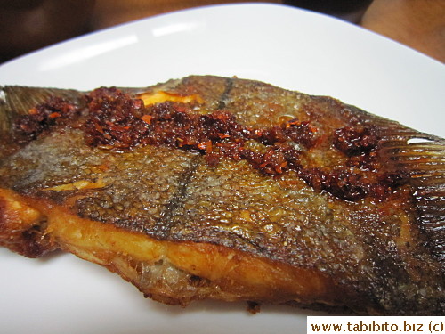 Eating the crispy chunky chili oil with panfried fish is nice
