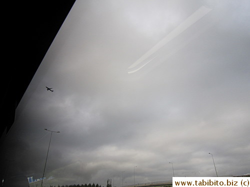 Close to the city now, captured a plane on the left side of the photo