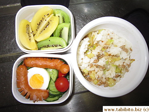 Ground pork and cabbage rice, marinated cucumber, hard-boiled egg, sausage, cherry tomato, kiwi fruit