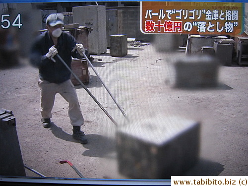 Team members gather safes found in the rubble left by the tsunami