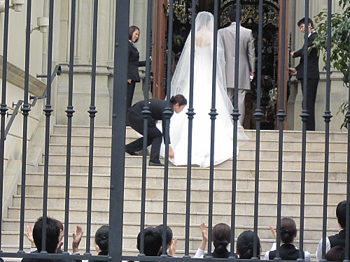 The couple turn around and bow to the guests in the church