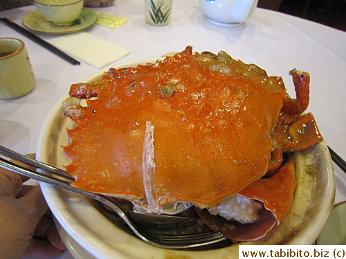 Mud crab over sticky rice in a pot