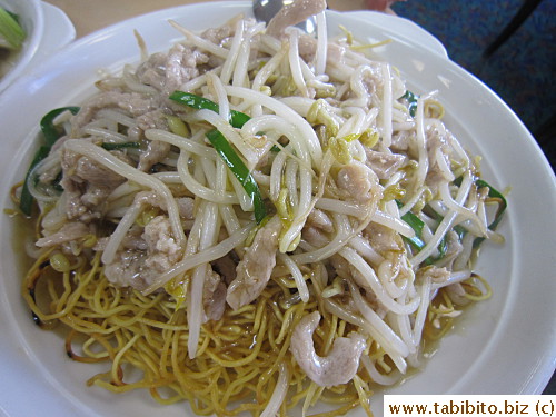 Pork and bean sprouts over wheat noodles