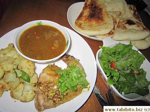 Our Indian dinner at home: leftover curry beef sauce, curried cauliflower, roasted chicken, salad, naan