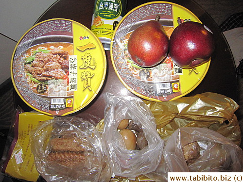 Breakfast of instant noodles, braised meat and fruit